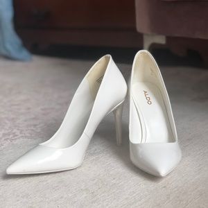 Aldo white patent pumps